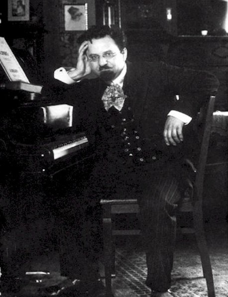 Sigfrid Karg-Elert seated at his piano